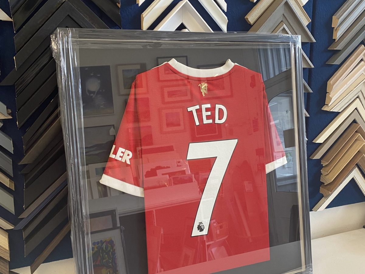A signed football shirt box-framed under glass, ready to collect.